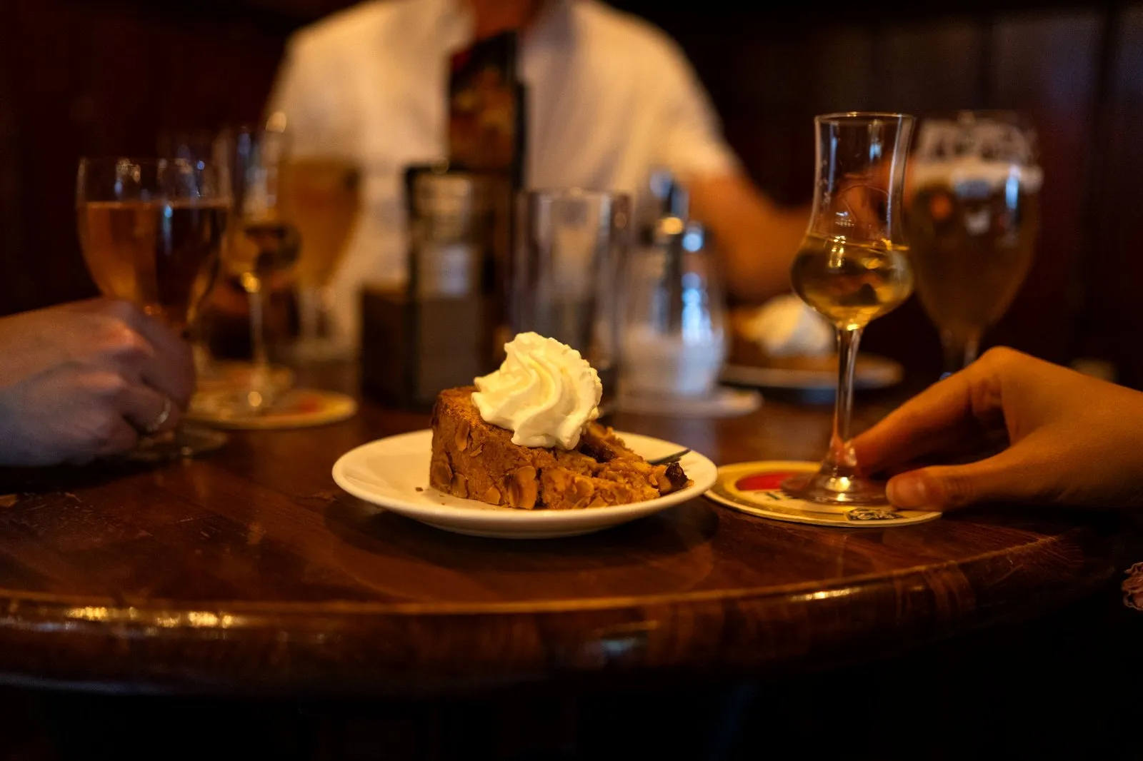 Slice of Dutch apple pie on a table in an Amsterdam brown cafe