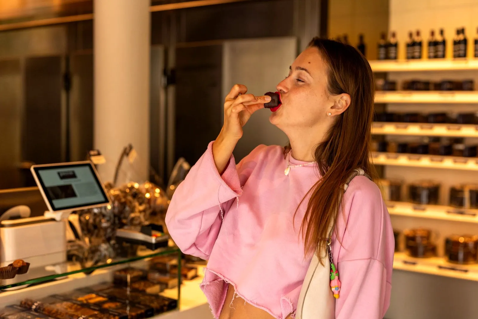 A guest tasting a chocolate in an Amsterdam chocolate shop