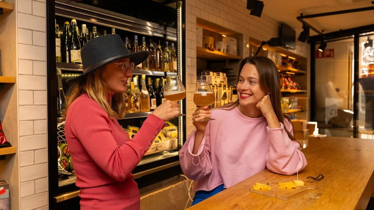 Woman enjoying wine and cheese tasting during a guided food experience in Amsterdam.