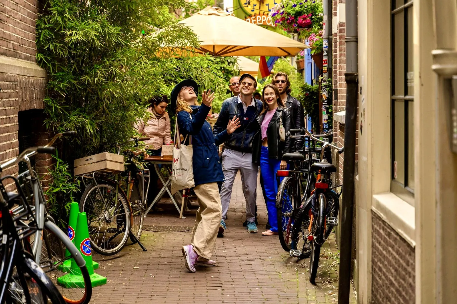 A guide leading a small group down a leafy hidden alley in Amsterdam