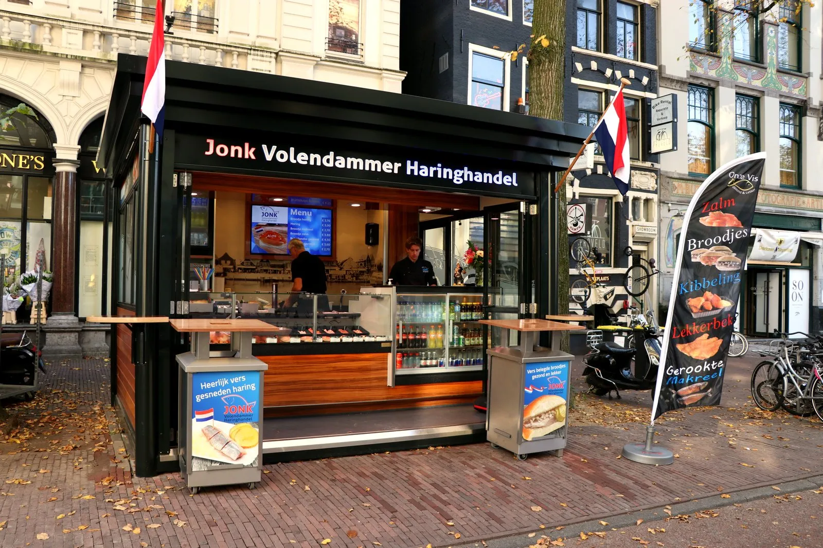 Dutch herring stall on an Amsterdam street with flags and signs