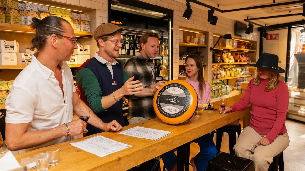 People exploring a local cheese shop in Amsterdam during a cheese tasting experience