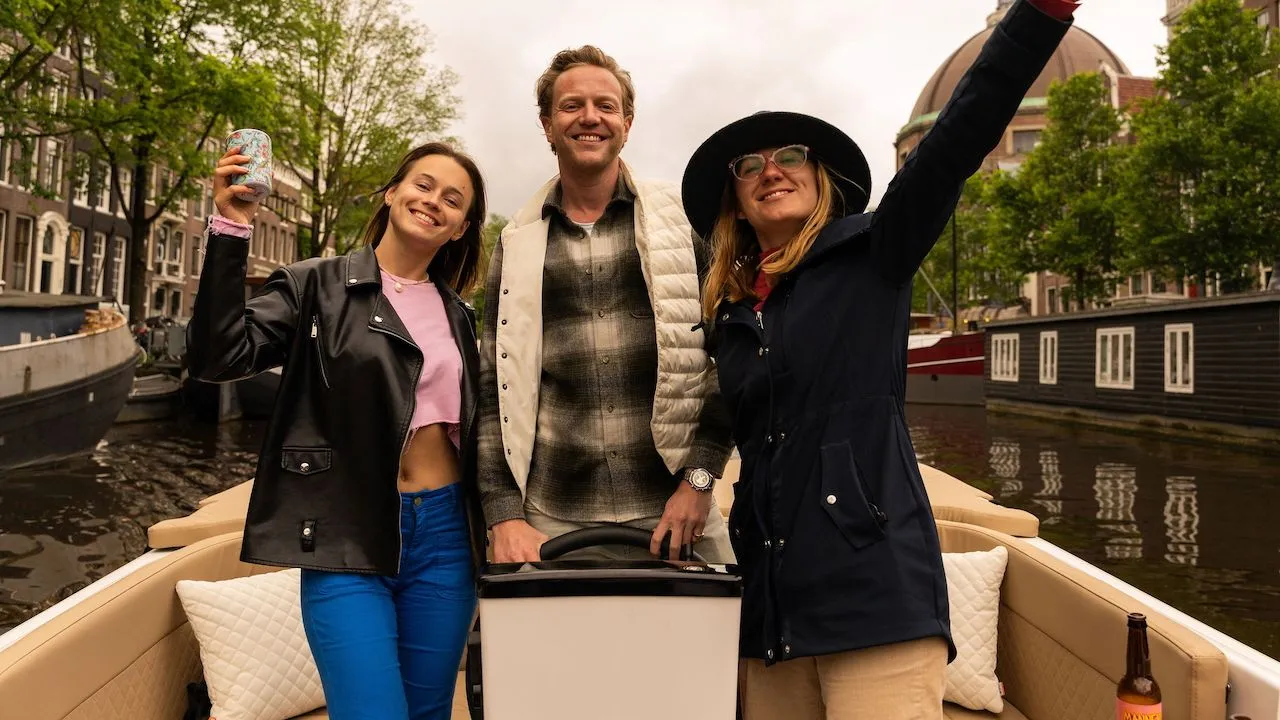 People enjoying a peaceful private boat tour through Amsterdam’s waterways.