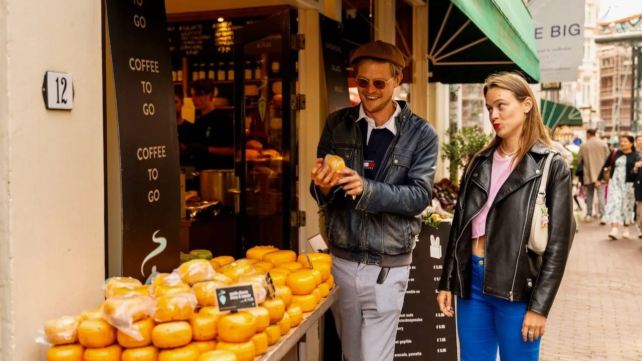 People exploring local Dutch cheese during a food experience in Amsterdam.