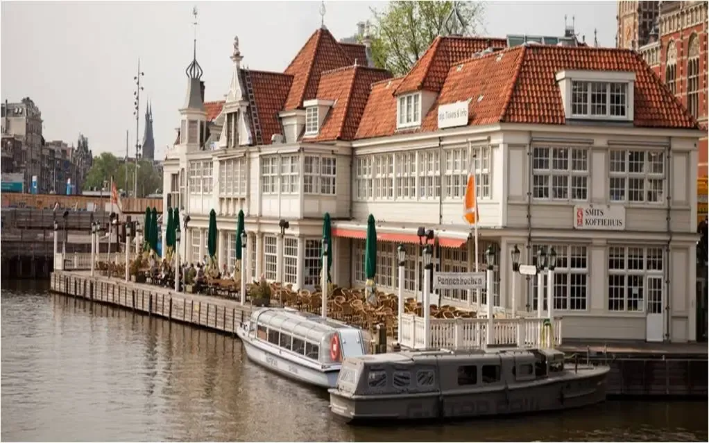 Loetje restaurant on an Amsterdam canal with a terrace and a boat moored in front