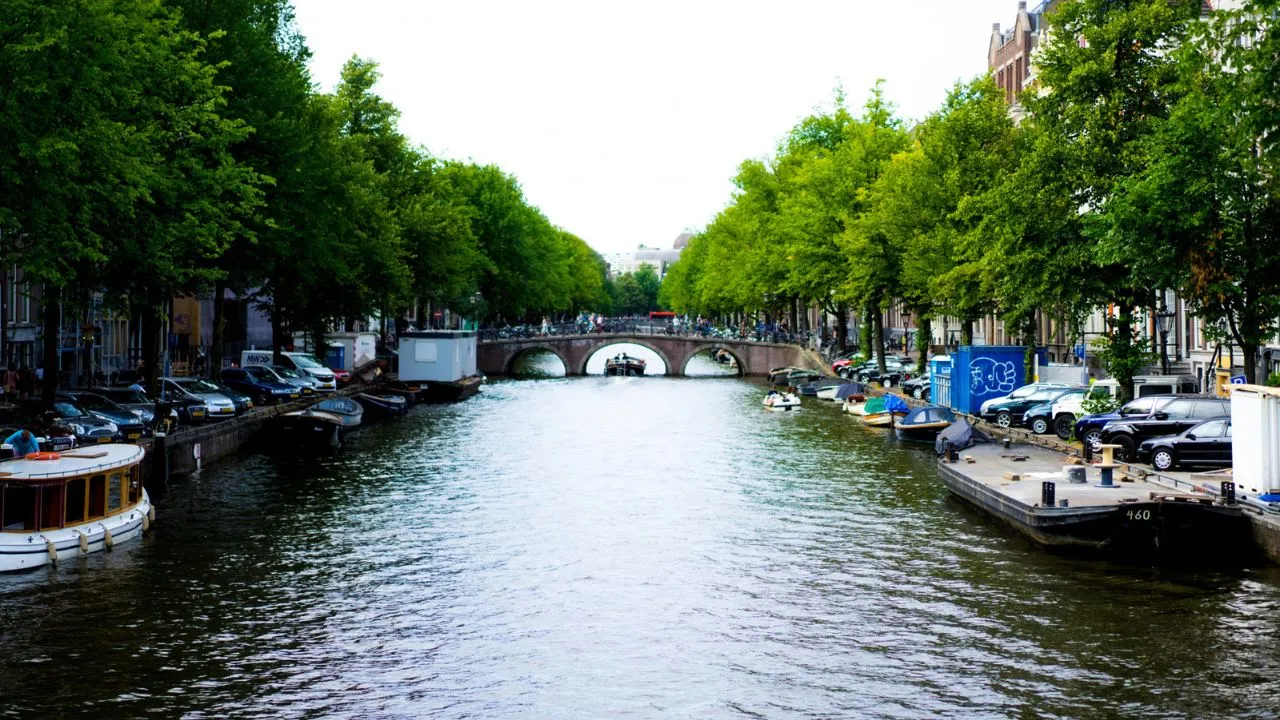 Scenic view of Amsterdam canals with historic townhouses reflected on the water